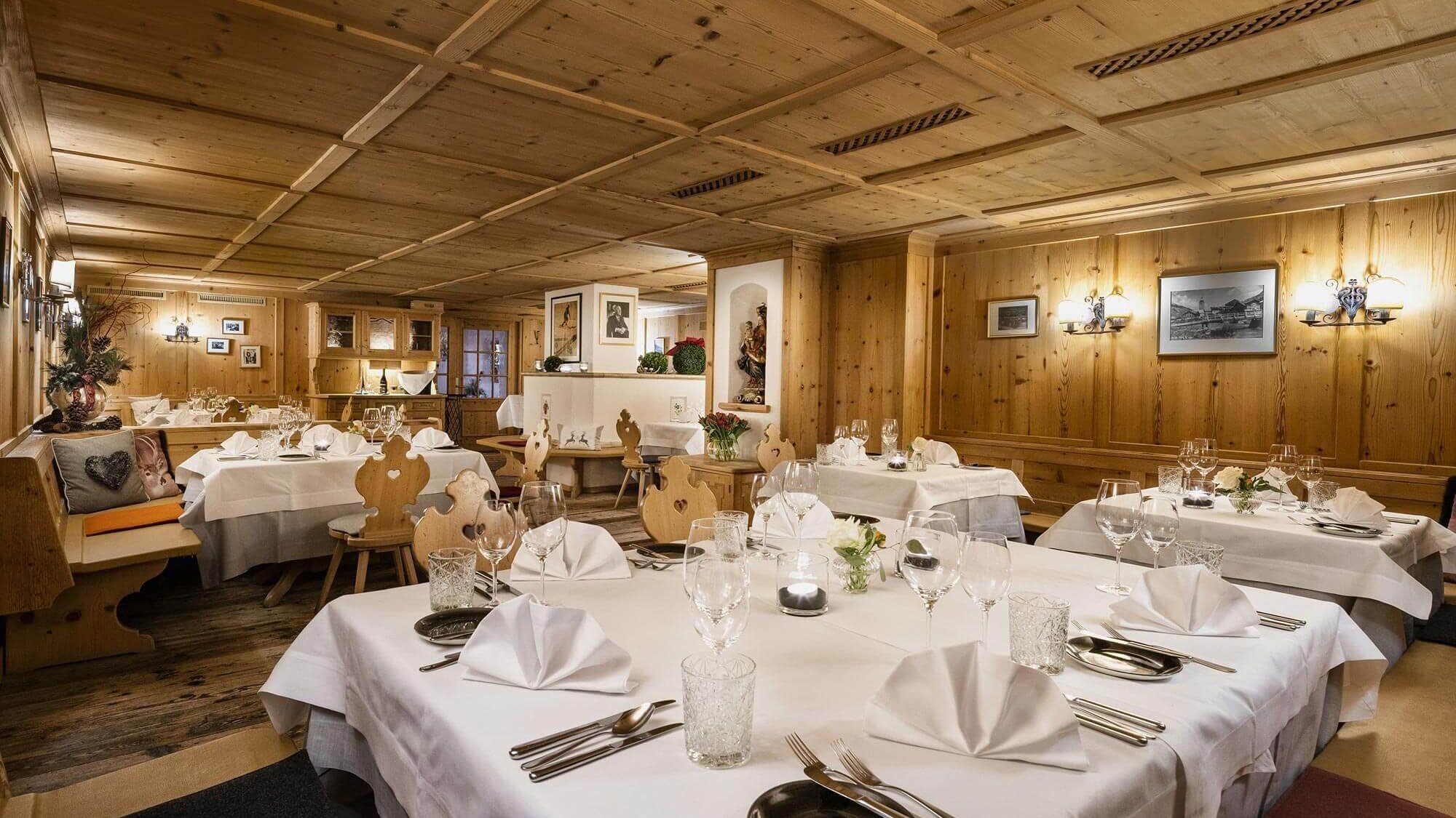 Gemütliches Restaurantambiente Elegante Tische mit weißen Tischdecken im Restaurantbereich aus Holzdekoren dekoriert