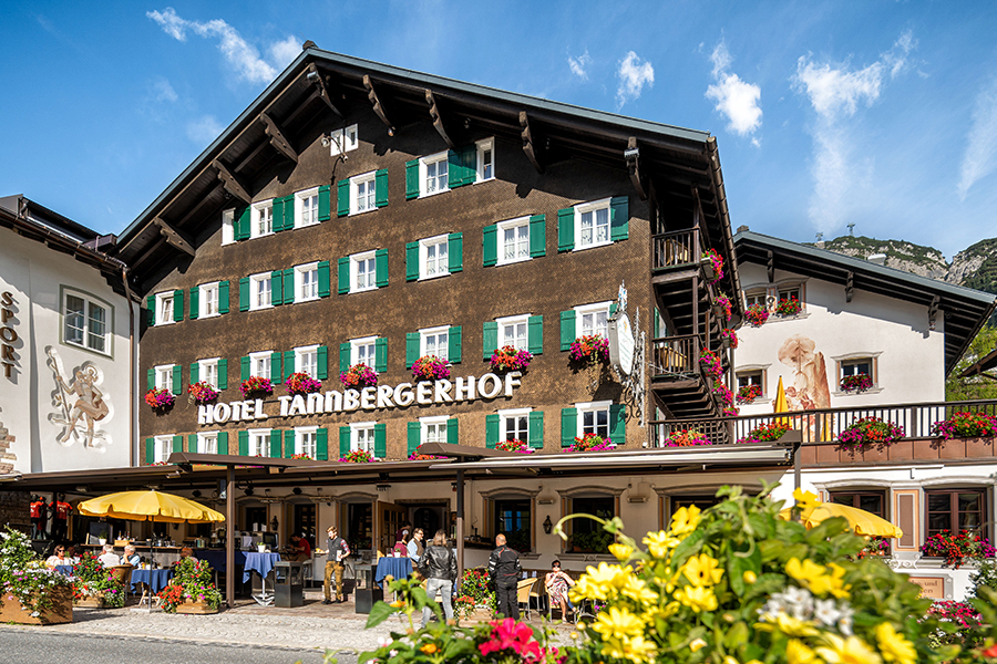 Alpenidylle am Tannbergerhof Das Hotel Tannbergerhof in Lech mit seiner blumengeschmückten Fassade und sonniger Terrasse © Foto Lehmann