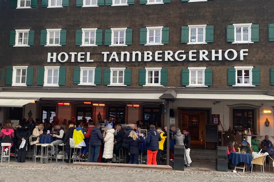Gemütliche Außenbereiche im Tannbergerhof Belebte Terrasse des Hotel Tannbergerhof mit Gästen in winterlicher Kleidung, während Heizstrahler für eine gemütliche Atmosphäre sorgen